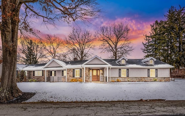 view of front of home featuring stone siding and covered porch