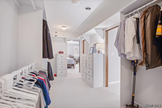 walk in closet featuring visible vents and carpet floors