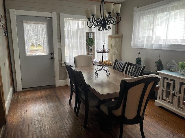 dining room with an inviting chandelier, dark hardwood / wood-style flooring, and a wealth of natural light