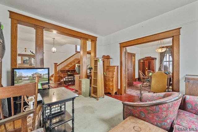 624 Oden St, Confluence, PA 15424 - living area featuring carpet, stairway, and decorative columns