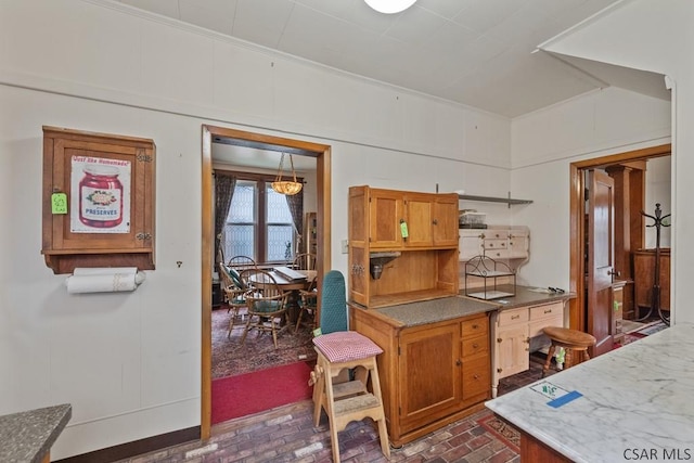 624 Oden St, Confluence, PA 15424 - kitchen with crown molding, brown cabinets, and brick patterned floor