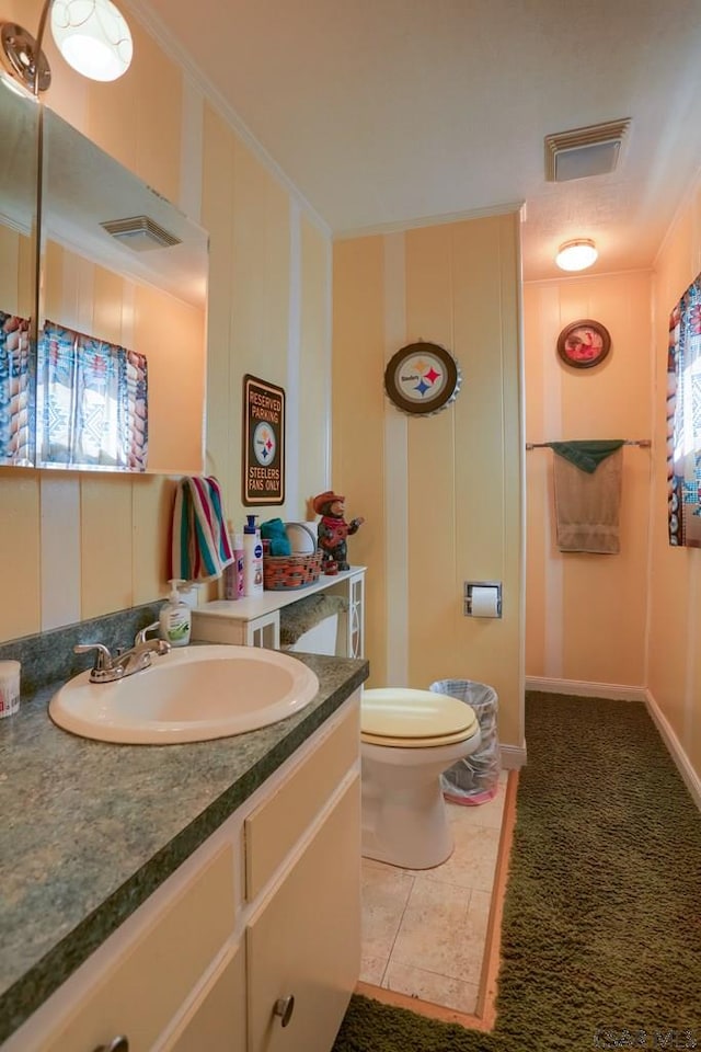 bathroom with visible vents, toilet, ornamental molding, tile patterned floors, and vanity