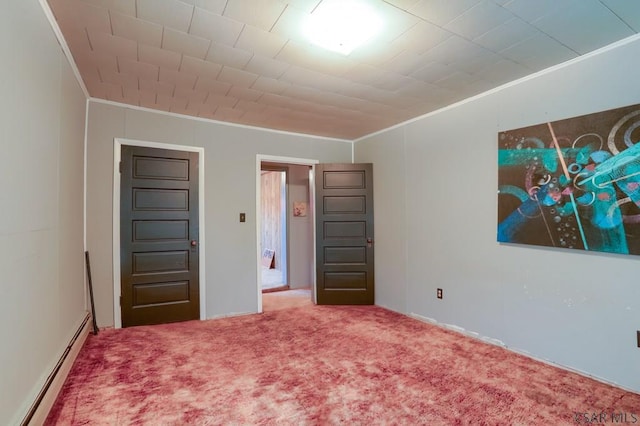 unfurnished bedroom featuring ornamental molding, carpet floors, and a baseboard radiator