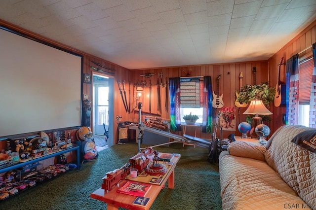 carpeted living area with wooden walls and ornamental molding