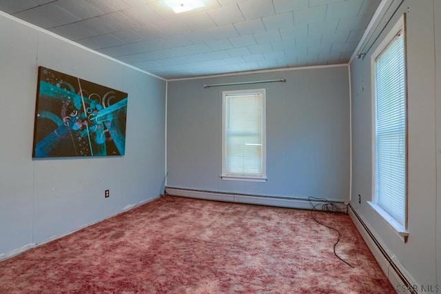 carpeted spare room with a baseboard heating unit and crown molding