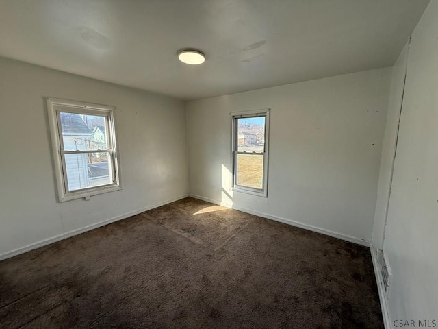 carpeted empty room with baseboards