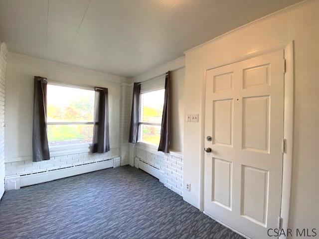 106 Lucetta St, Johnstown, PA 15905 - foyer with dark carpet and a baseboard radiator