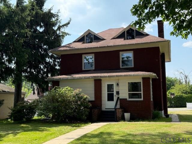 106 Lucetta St, Johnstown, PA 15905 - american foursquare style home with entry steps, a front lawn, a chimney, and brick siding