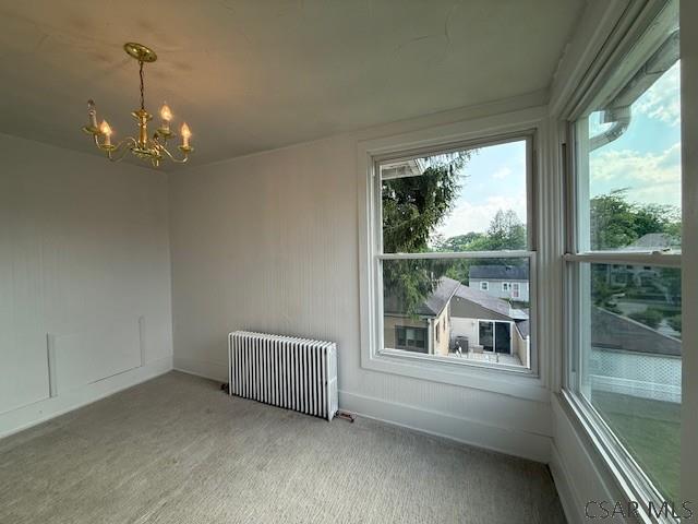 106 Lucetta St, Johnstown, PA 15905 - unfurnished sunroom with radiator heating unit and a chandelier