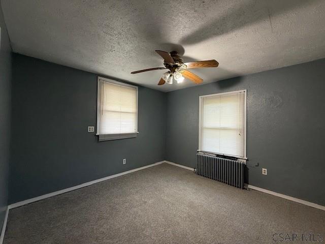 106 Lucetta St, Johnstown, PA 15905 - carpeted spare room with a ceiling fan, a textured ceiling, radiator heating unit, and baseboards