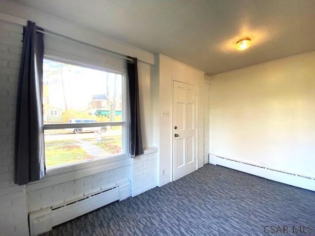 106 Lucetta St, Johnstown, PA 15905 - spare room featuring plenty of natural light, dark carpet, and a baseboard heating unit
