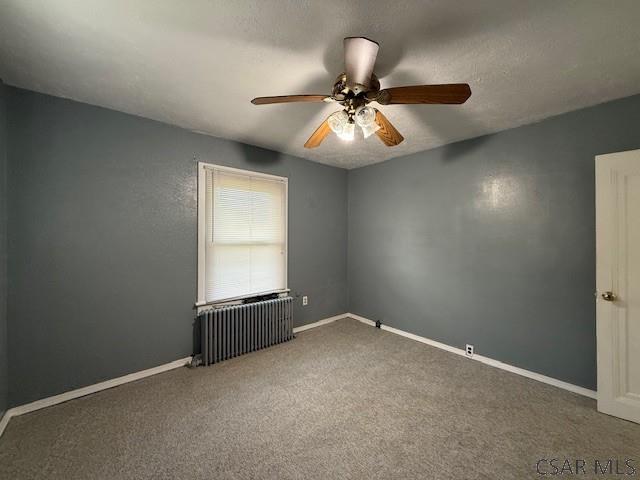 106 Lucetta St, Johnstown, PA 15905 - carpeted spare room featuring radiator heating unit, a ceiling fan, and baseboards