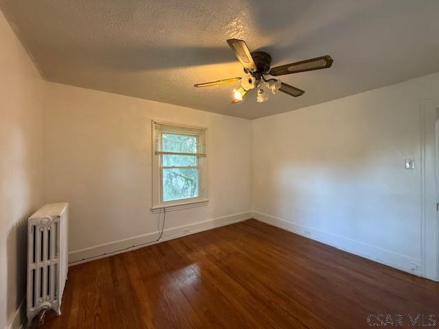 106 Lucetta St, Johnstown, PA 15905 - spare room featuring radiator, wood finished floors, baseboards, a ceiling fan, and a textured ceiling