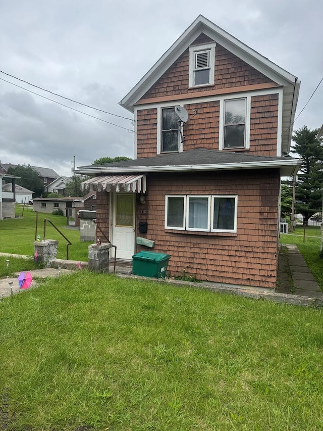 116 Blawn St, Johnstown, PA 15906 - rear view of house with a lawn and roof with shingles