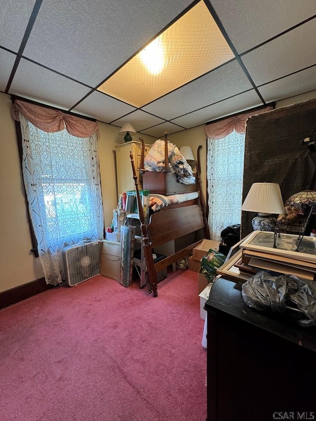 carpeted bedroom with a drop ceiling