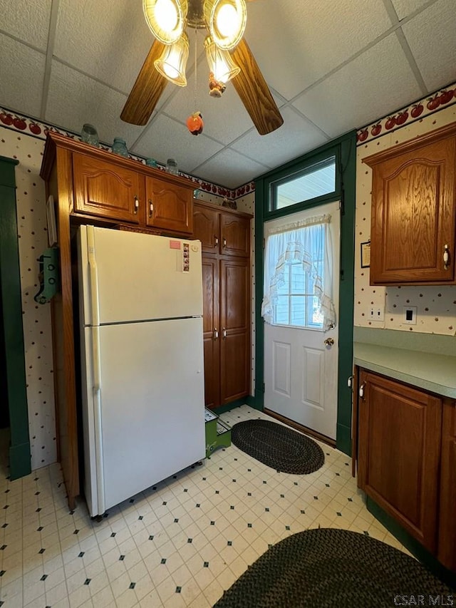 kitchen featuring ceiling fan, a paneled ceiling, and white fridge