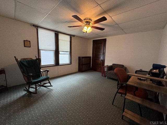 home office with carpet flooring, a drop ceiling, and ceiling fan