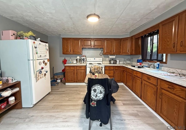 304 Oak St, Conemaugh, PA 15909 - kitchen featuring white appliances, a sink, brown cabinets, and light countertops