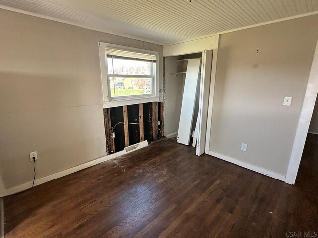 spare room featuring crown molding and hardwood / wood-style floors