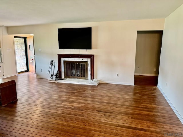 1502 Goucher St, Johnstown, PA 15905 - unfurnished living room with hardwood / wood-style floors, a glass covered fireplace, and baseboards