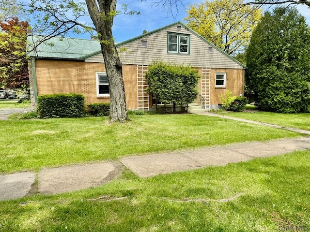 1502 Goucher St, Johnstown, PA 15905 - view of front facade featuring brick siding, a front lawn, and entry steps