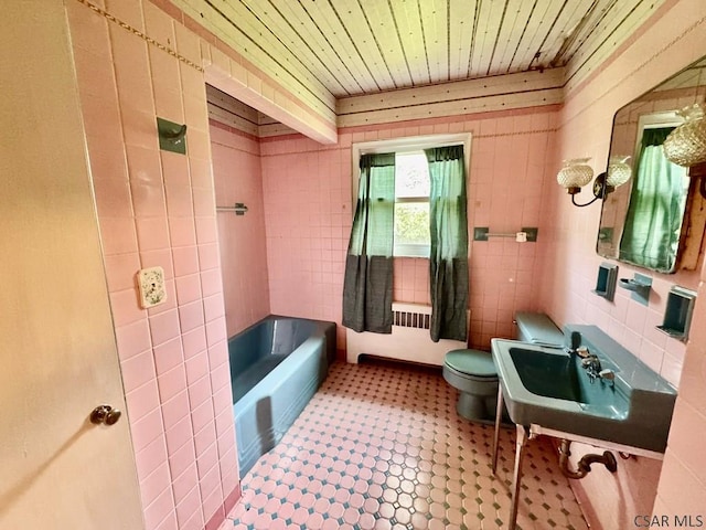 1502 Goucher St, Johnstown, PA 15905 - bathroom featuring radiator, a tub to relax in, wooden ceiling, tile patterned floors, and toilet