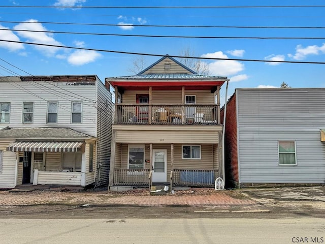 front facade featuring a balcony and a porch