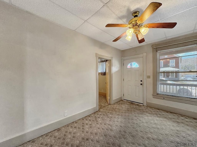 entryway featuring carpet floors, a paneled ceiling, and ceiling fan