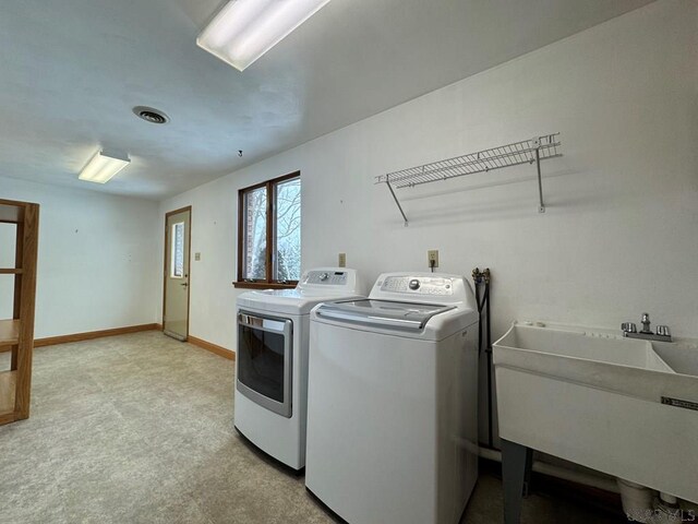 washroom with sink and washer and dryer