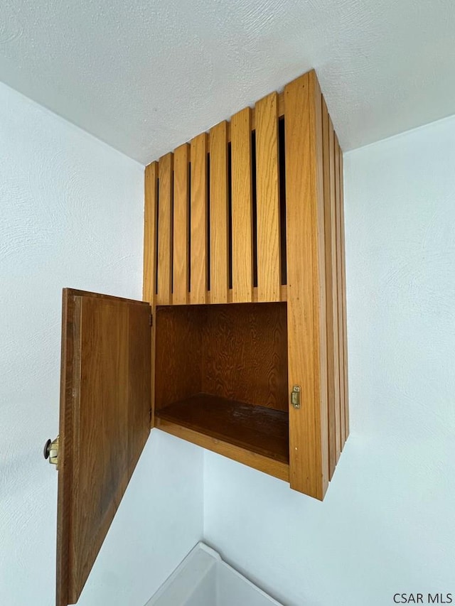 interior details featuring a textured ceiling