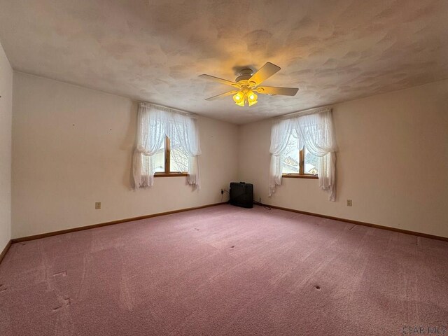 carpeted empty room with ceiling fan