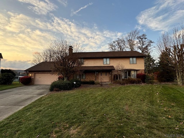 view of front property with a garage and a yard