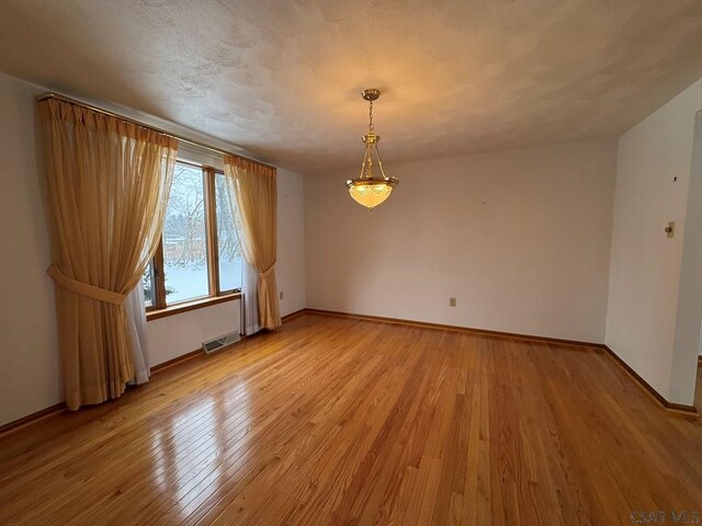 unfurnished room featuring hardwood / wood-style floors