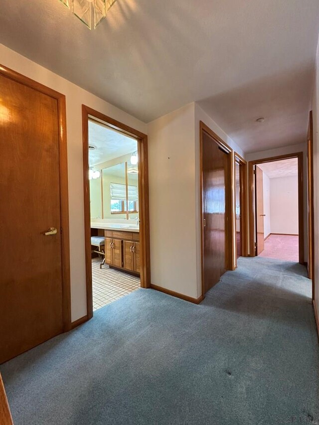 hallway featuring light colored carpet