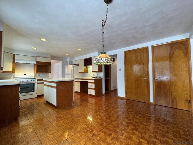 kitchen featuring white appliances, white cabinetry, dark parquet flooring, a kitchen island, and decorative light fixtures