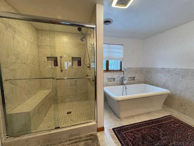 bathroom with tile walls, tile patterned flooring, and plus walk in shower