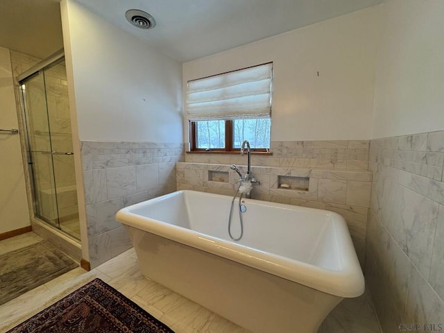 bathroom with tile walls and plus walk in shower