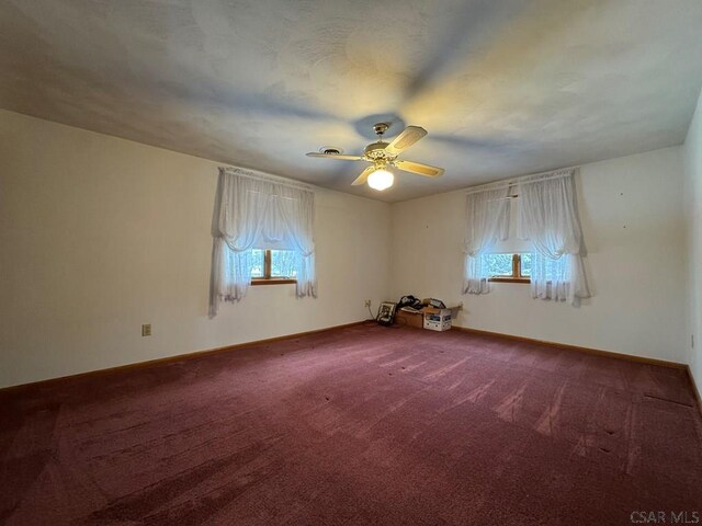 carpeted empty room with ceiling fan