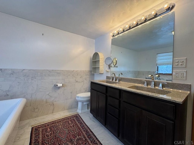 bathroom featuring tile walls, a bath, vanity, and toilet