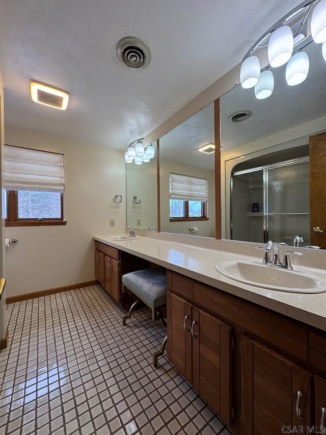 bathroom with vanity, tile patterned floors, and a shower with shower door