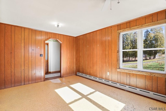 empty room with a baseboard radiator and a healthy amount of sunlight