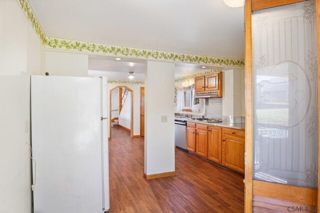 kitchen with stainless steel appliances and dark hardwood / wood-style floors