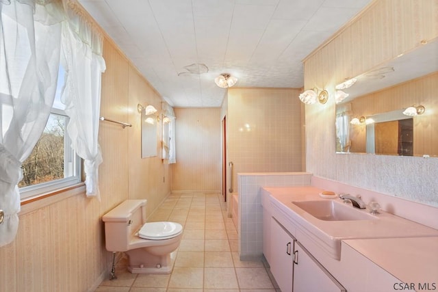 full bathroom featuring tile patterned flooring, vanity, plus walk in shower, toilet, and wood walls