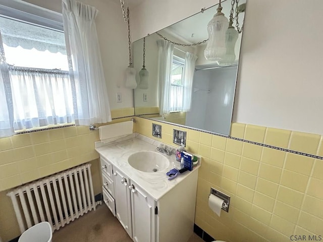 2269 Sunshine Ave, Johnstown, PA 15905 - bathroom featuring radiator, tile walls, vanity, and a wainscoted wall