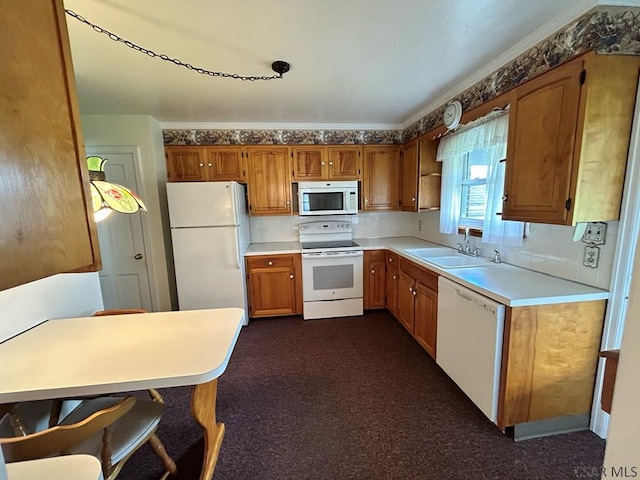 2269 Sunshine Ave, Johnstown, PA 15905 - kitchen featuring white appliances, a sink, brown cabinets, light countertops, and dark colored carpet