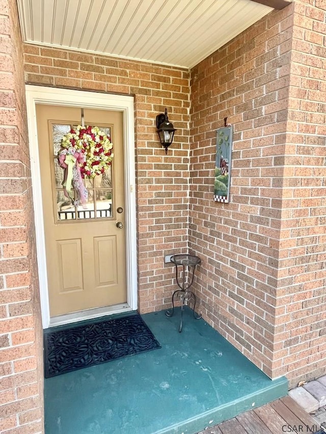 property entrance with brick siding