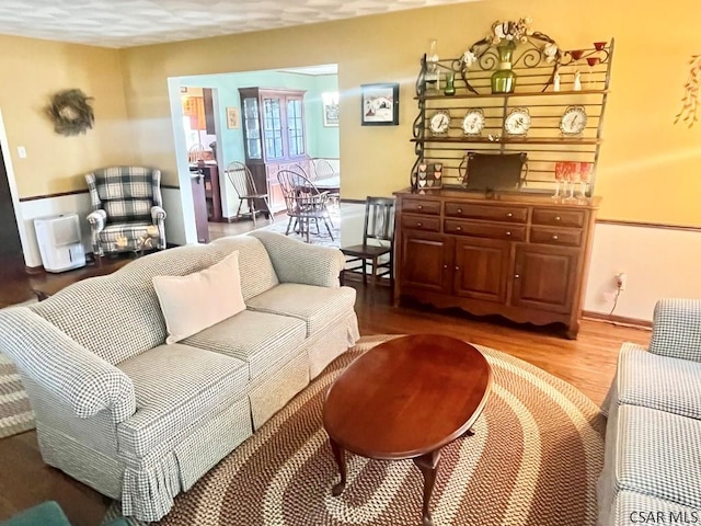 living room with baseboards and wood finished floors