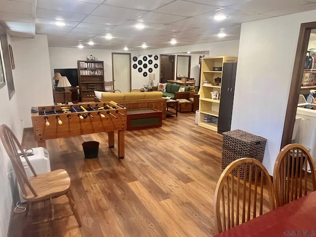 game room featuring wood finished floors and a drop ceiling