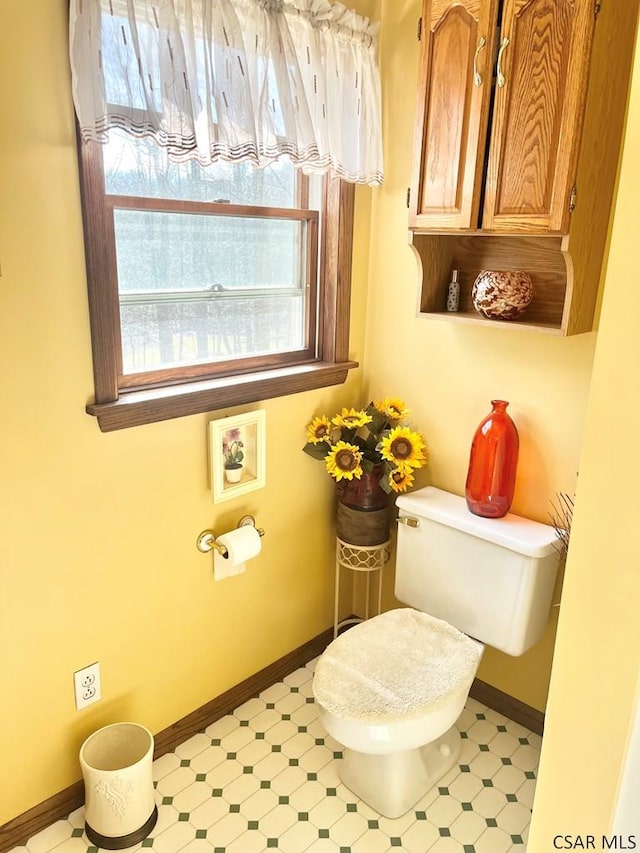 bathroom featuring tile patterned floors, toilet, and baseboards