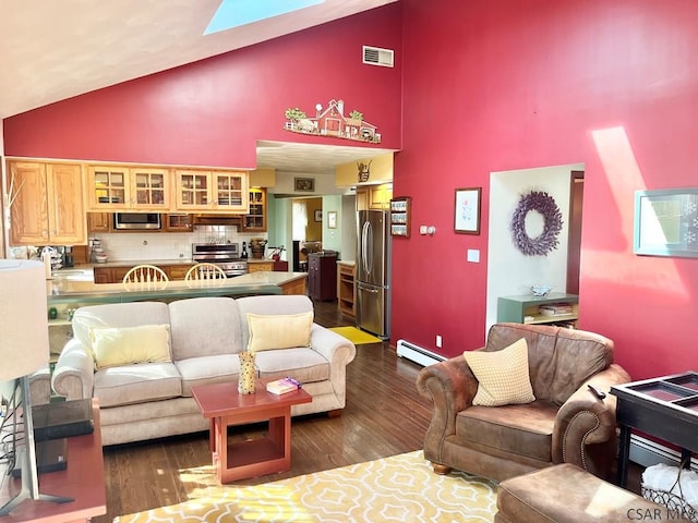 living room featuring visible vents, dark wood-type flooring, baseboard heating, a skylight, and high vaulted ceiling